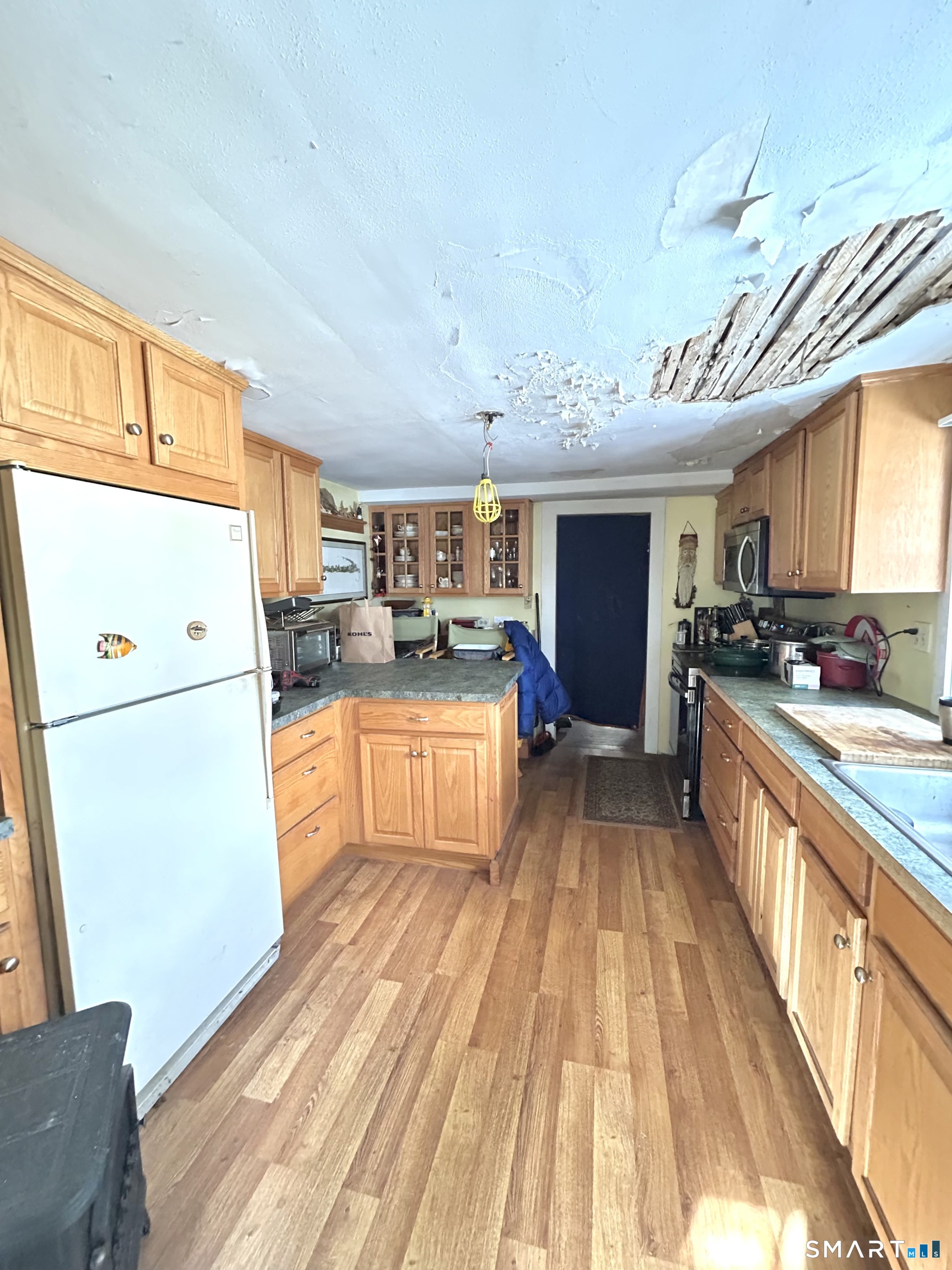 64 Bridge Street Canton, CT 06019 - Photo 5 of 12 a kitchen with a refrigerator and a stove