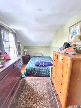 a bedroom with a bed and a dresser