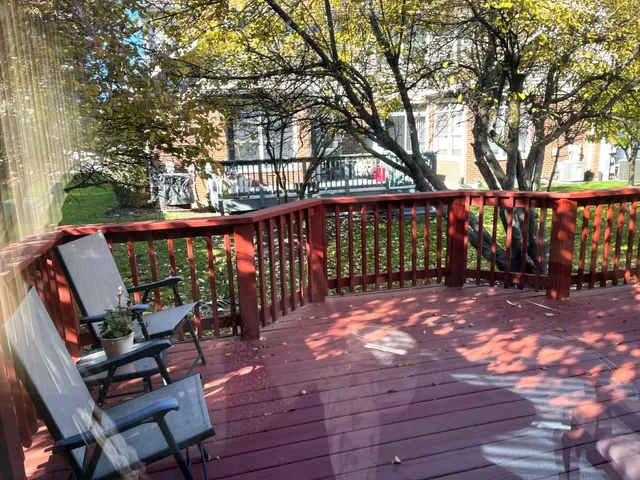 a view of deck with furniture and trees