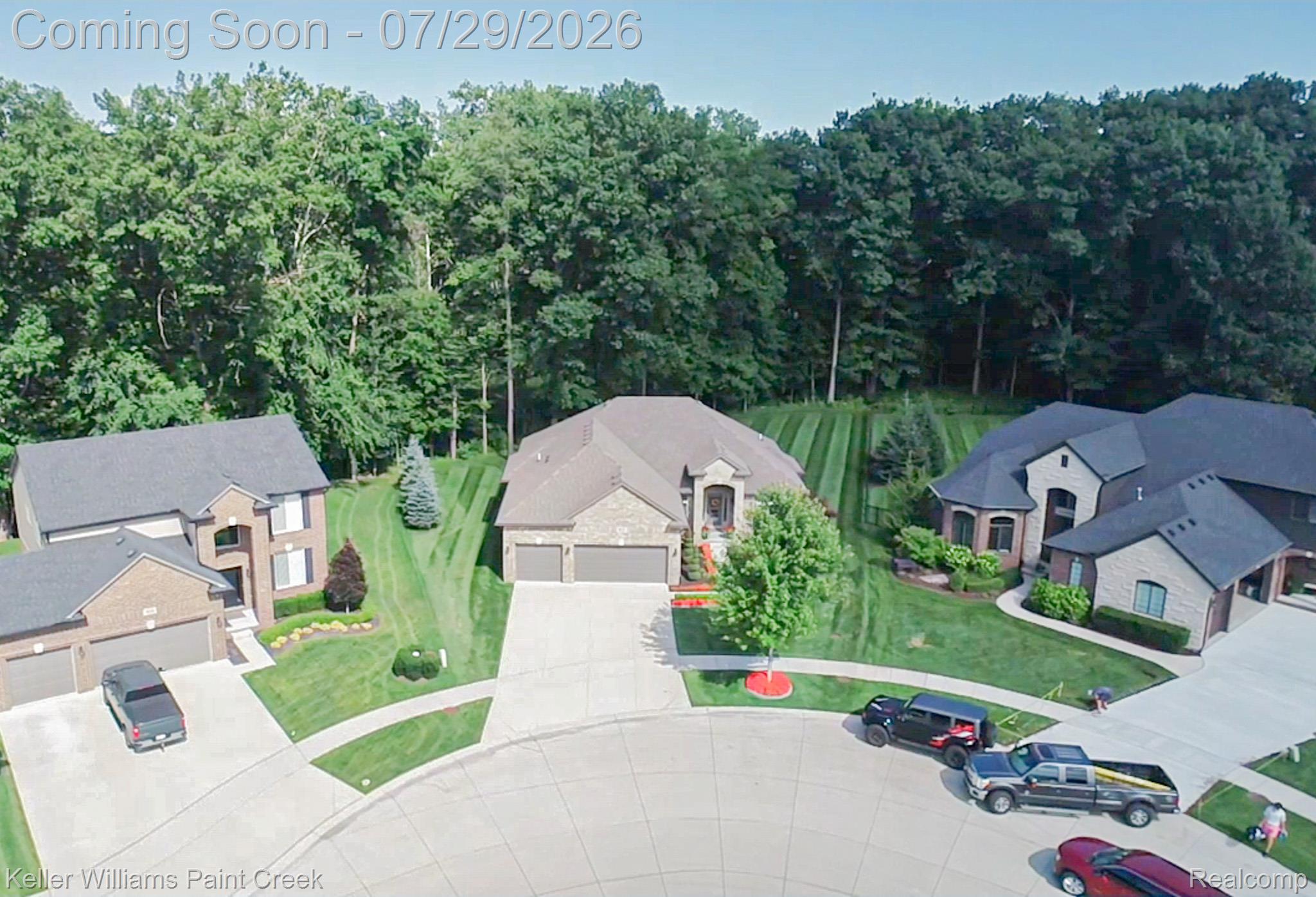 49118 Ridgeview Drive Macomb, MI 48044 - Photo 51 of 57 Brick and stone facade residence featuring a multi-car garage, mature landscaping, and a substantial driveway