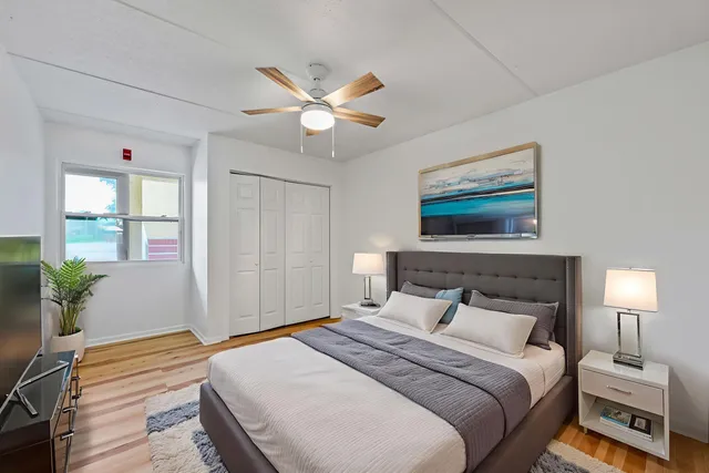 a bedroom with a bed and a chandelier