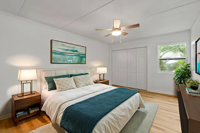 a bedroom with a large bed and a chandelier