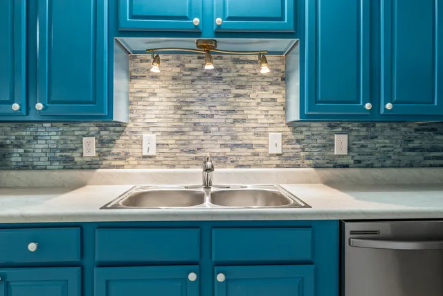 a kitchen with a sink and cabinets