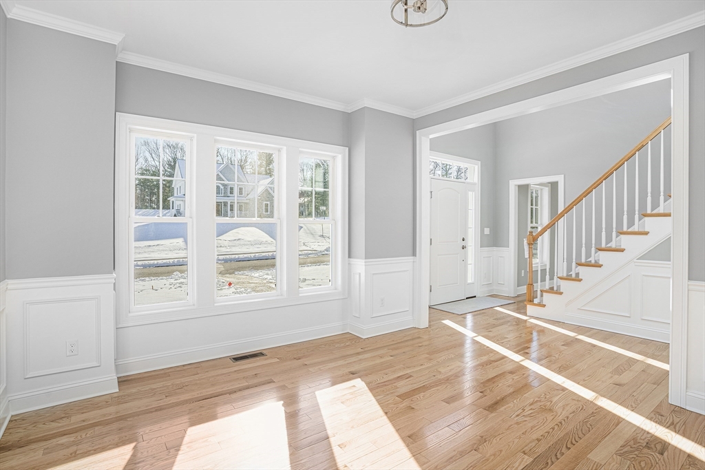 11 Cherry Tree Lane Attleboro, MA 02703 - Photo 4 of 10 a view of an empty room with wooden floor and a window