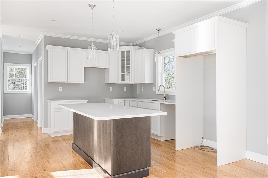 11 Cherry Tree Lane Attleboro, MA 02703 - Photo 7 of 10 a kitchen with a sink a stove a refrigerator and white cabinets