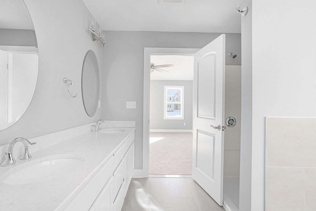 11 Cherry Tree Lane Attleboro, MA 02703 - Photo 8 of 10 a bathroom with a tub sink and mirror