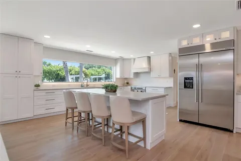 a kitchen with a sink and large window