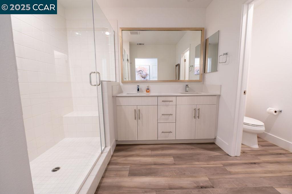 9877 MacArthur Boulevard, Unit E Oakland, CA 94605 - Photo 9 of 13 a bathroom with a sink a toilet and shower