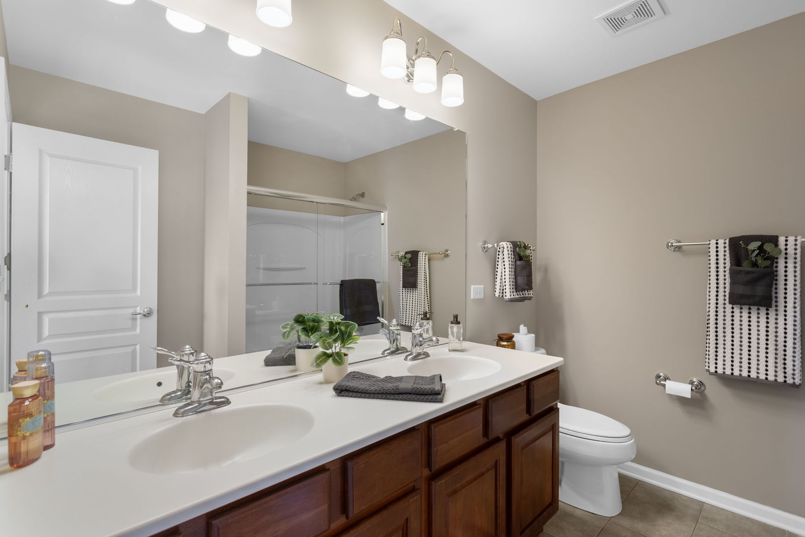3303 Redbud Drive Lindenhurst, IL 60046 - Photo 11 of 25 a bathroom with a double vanity sink mirror and toilet