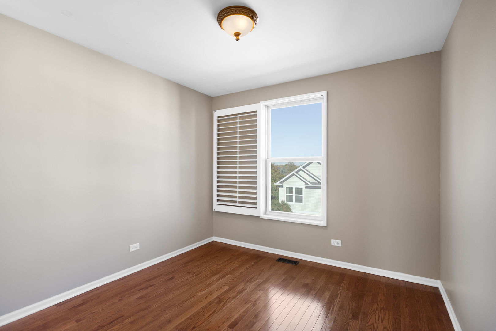 3303 Redbud Drive Lindenhurst, IL 60046 - Photo 12 of 25 an empty room with wooden floor and windows