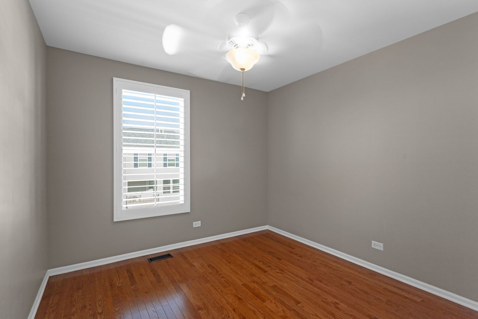 3303 Redbud Drive Lindenhurst, IL 60046 - Photo 14 of 25 an empty room with wooden floor and windows