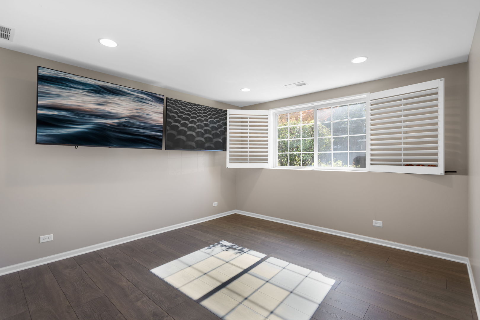 3303 Redbud Drive Lindenhurst, IL 60046 - Photo 16 of 25 a view of an empty room with a window and wooden floor
