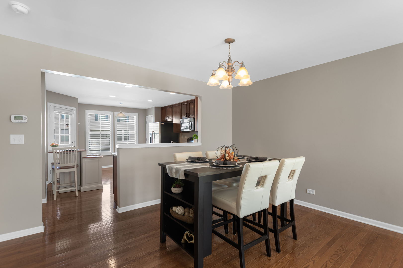 3303 Redbud Drive Lindenhurst, IL 60046 - Photo 7 of 25 a view of a dining room with furniture wooden floor and chandelier