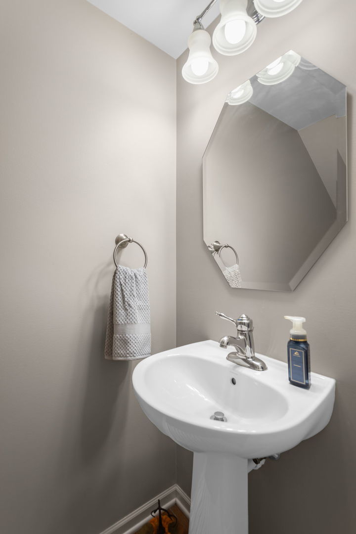 3303 Redbud Drive Lindenhurst, IL 60046 - Photo 8 of 25 a bathroom with a sink a mirror and vanity