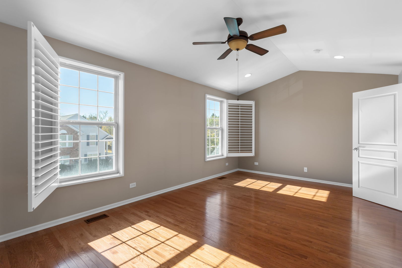 3303 Redbud Drive Lindenhurst, IL 60046 - Photo 10 of 25 a view of an empty room with wooden floor and a window