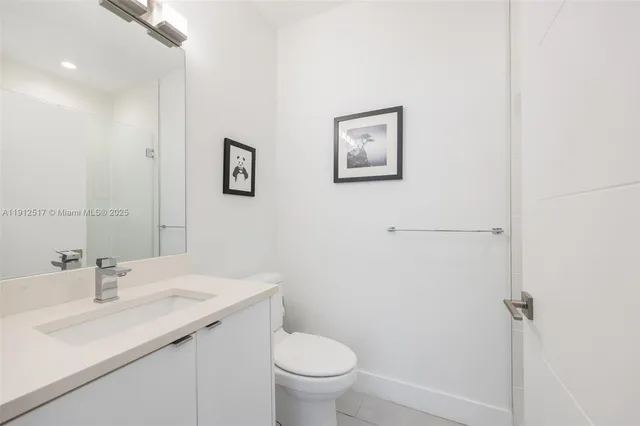 a bathroom with a sink toilet and a mirror
