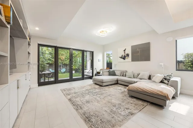 a living room with furniture and large windows