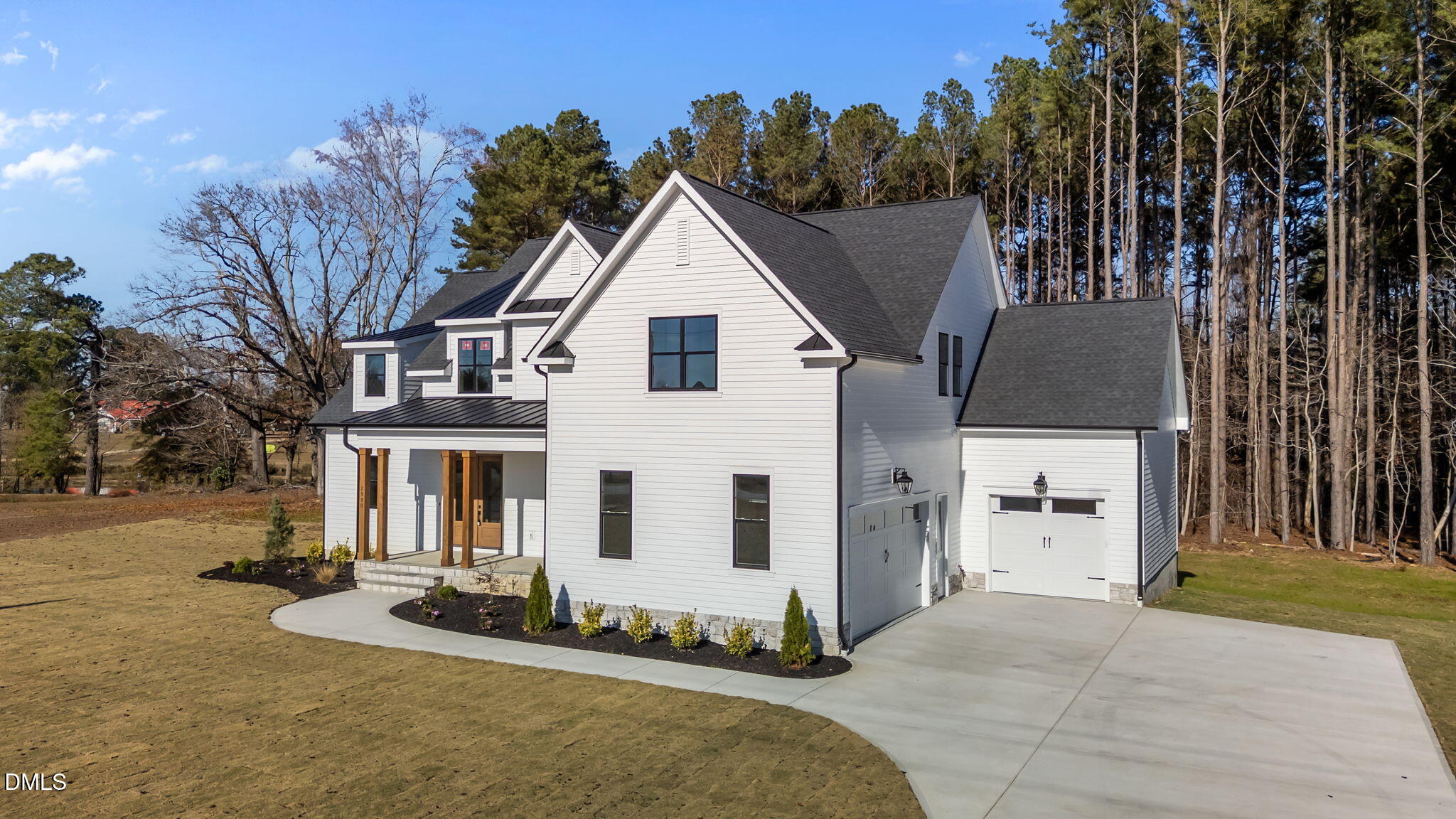 2590 Lassiter Road Four Oaks, NC 27524 - Photo 5 of 72 a view of a white house with a yard and tree s