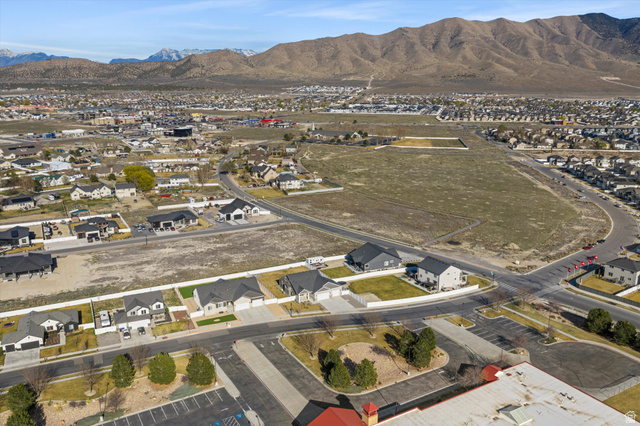 3938 North Wood Road Eagle Mountain, UT 84005 - Photo 47 of 55 Aerial view of property and surrounding area with nearby suburban area and a mountainous background