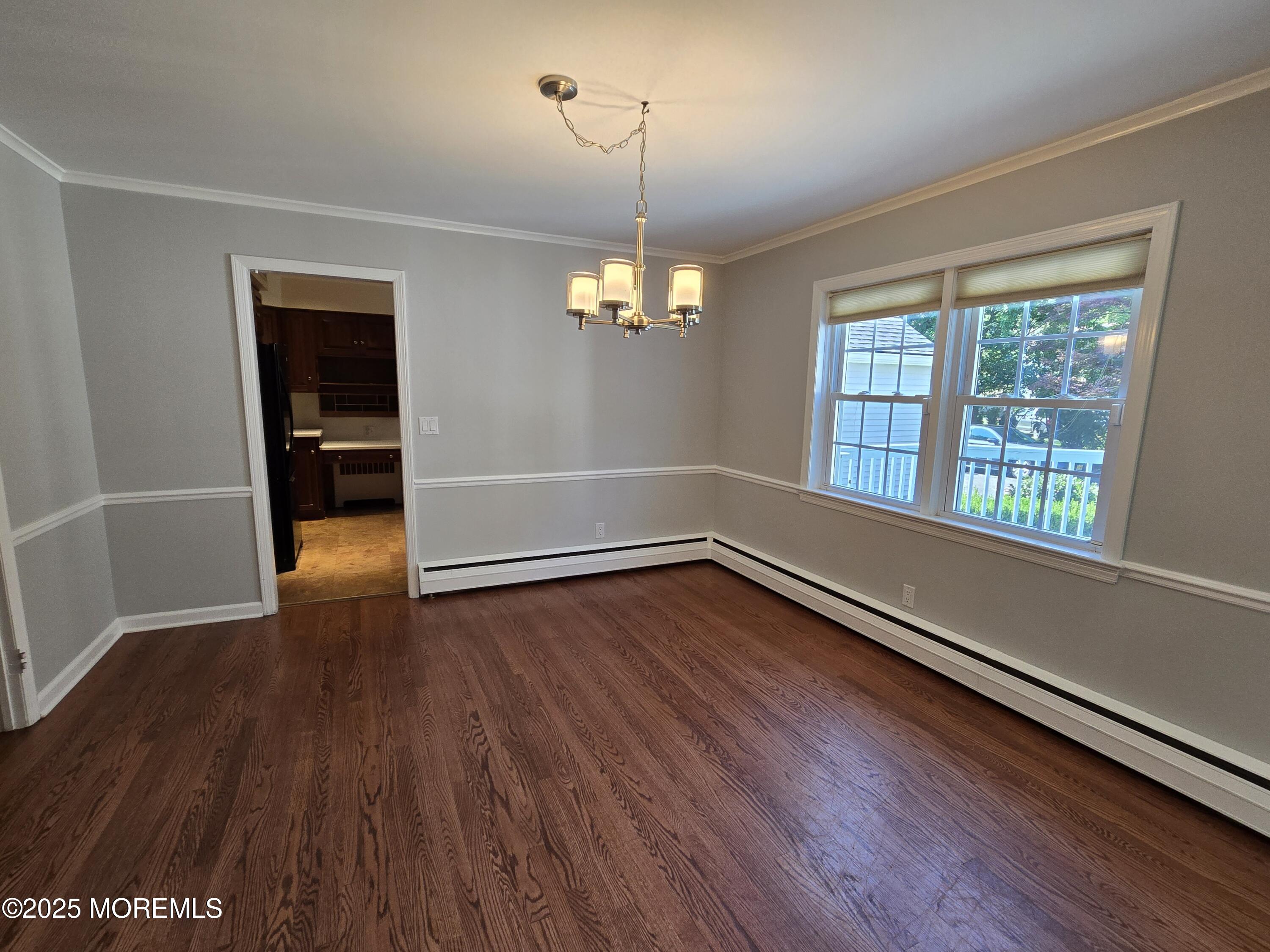 77 Dutch Lane Road Freehold, NJ 07728 - Photo 12 of 50 an empty room with wooden floor and windows
