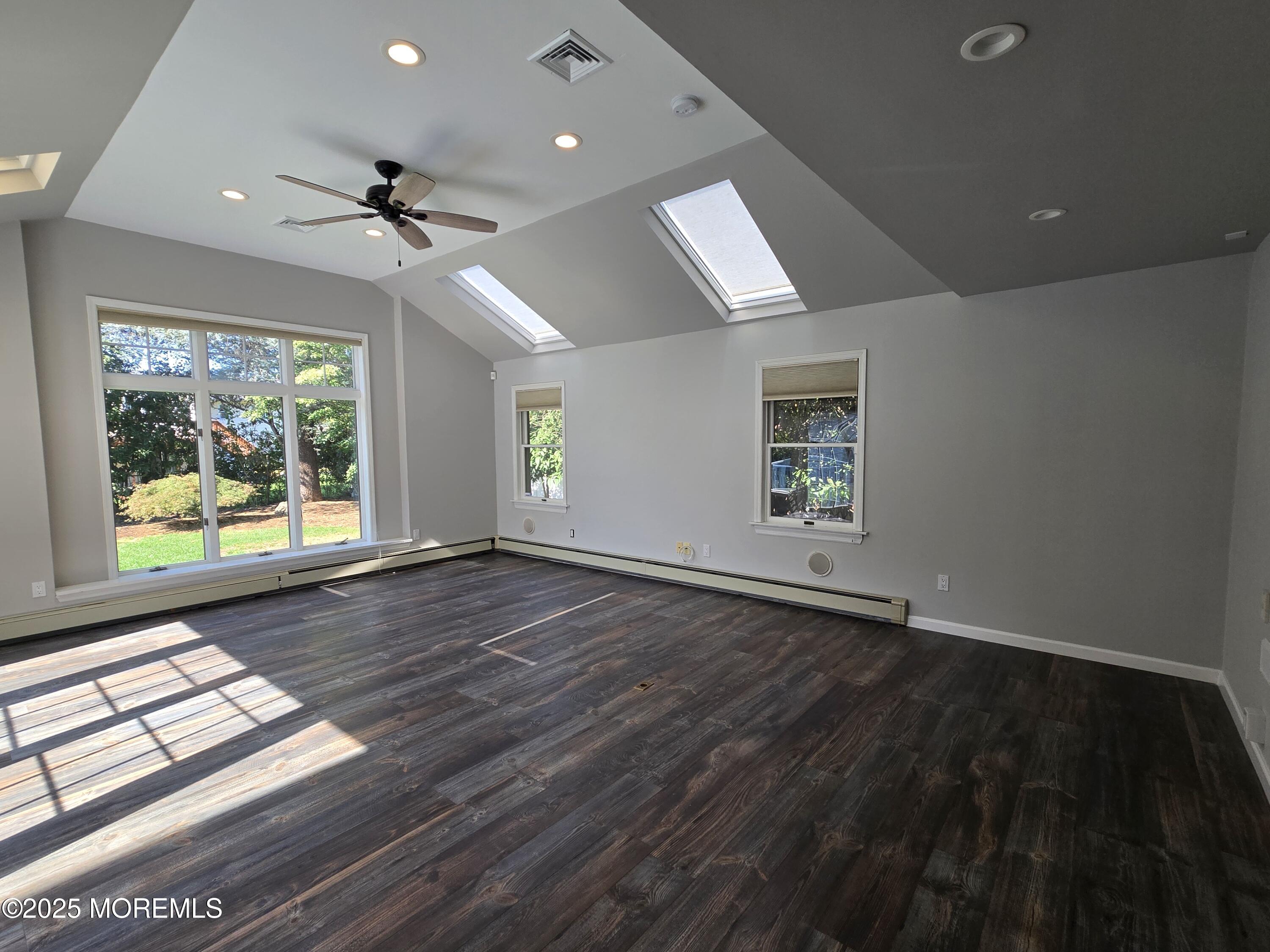 77 Dutch Lane Road Freehold, NJ 07728 - Photo 14 of 50 an empty room with wooden floor fan and windows
