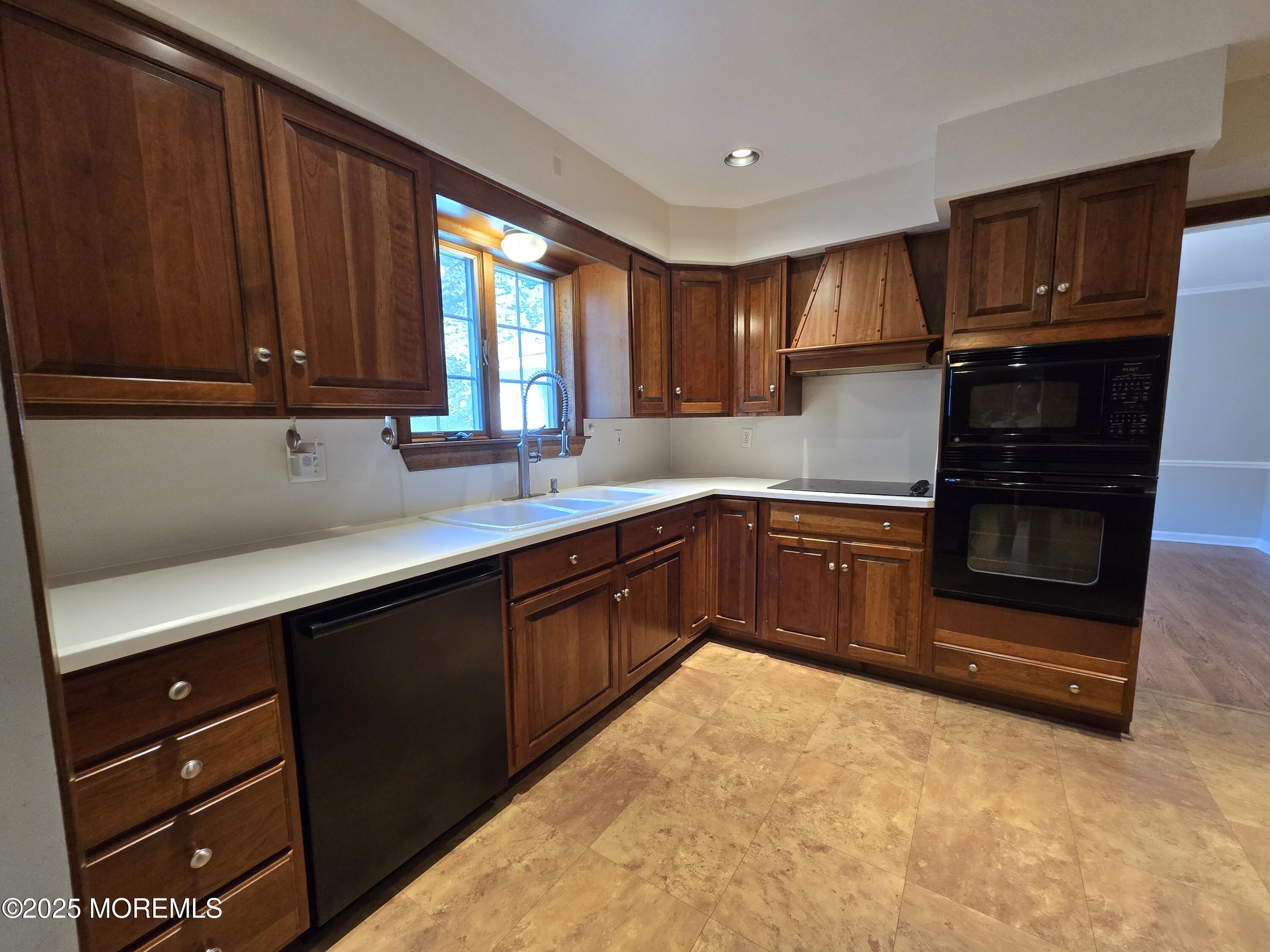 77 Dutch Lane Road Freehold, NJ 07728 - Photo 20 of 50 a kitchen with stainless steel appliances granite countertop a sink stove and cabinets