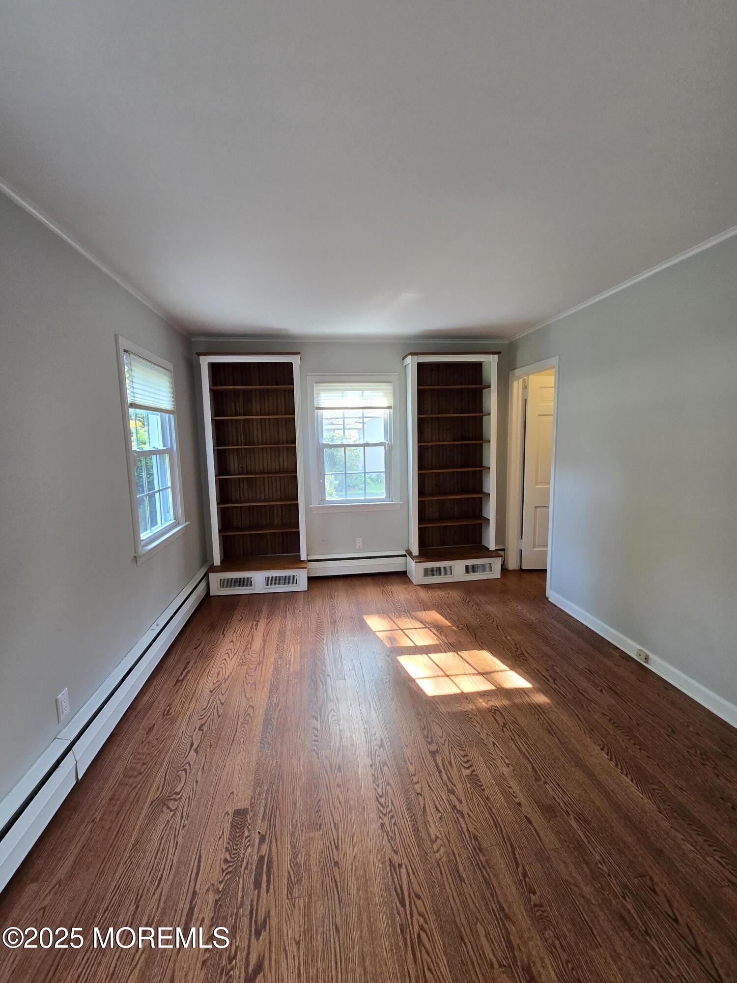 77 Dutch Lane Road Freehold, NJ 07728 - Photo 25 of 50 an empty room with wooden floor and windows