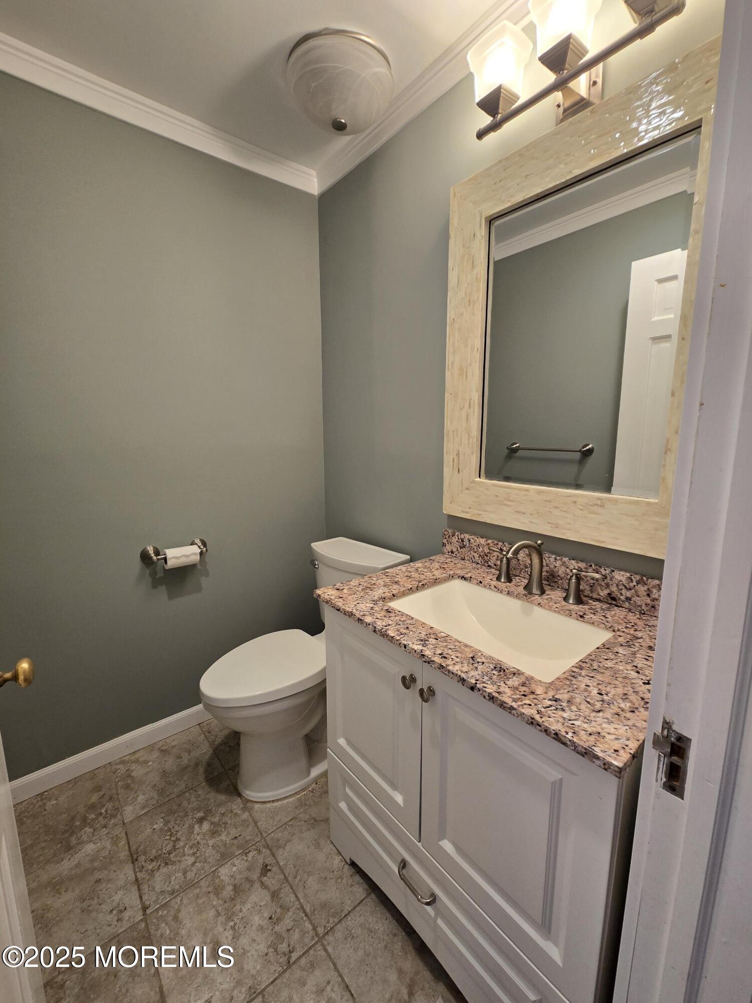 77 Dutch Lane Road Freehold, NJ 07728 - Photo 28 of 50 a bathroom with a granite countertop toilet sink and mirror