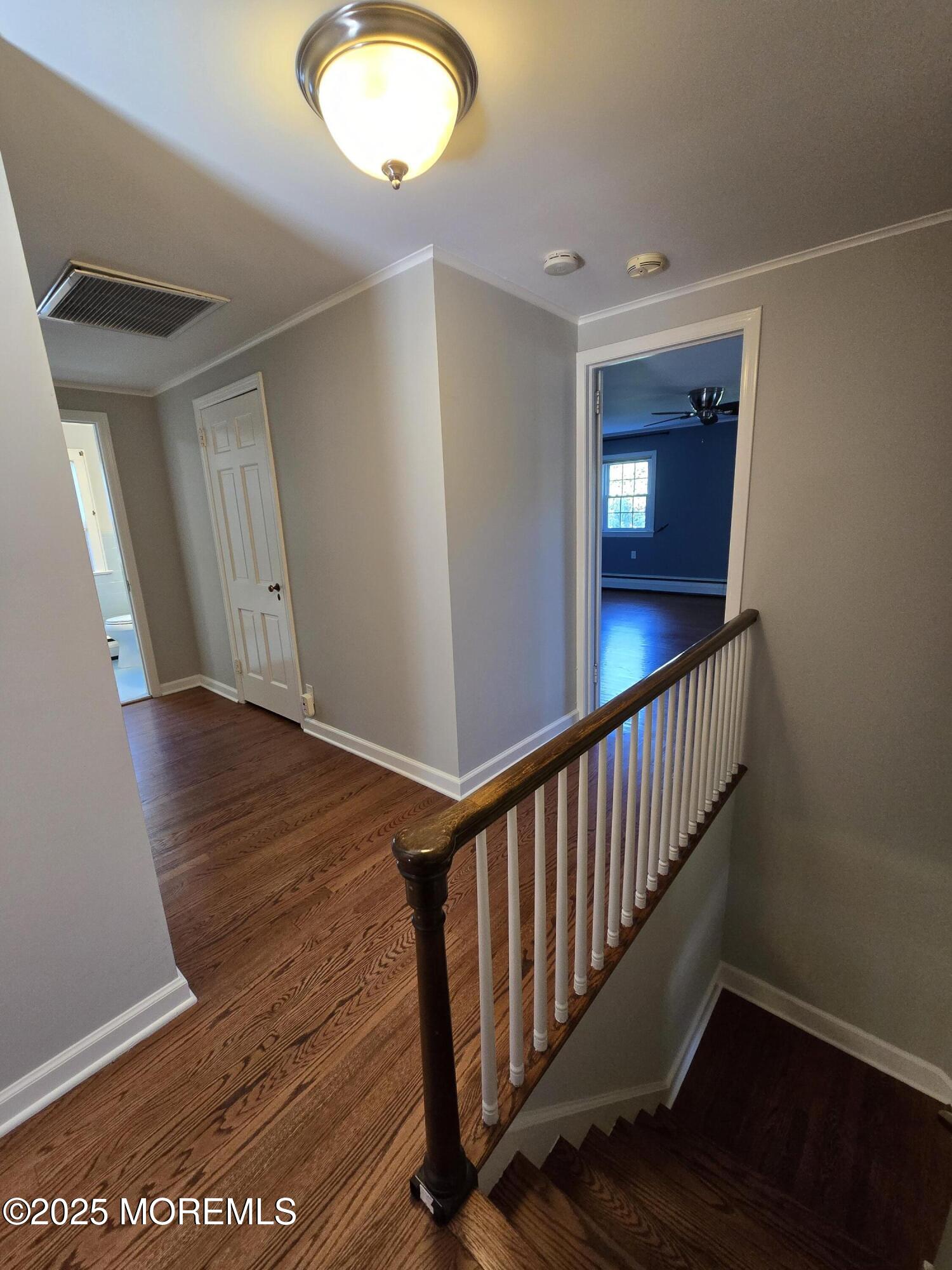 77 Dutch Lane Road Freehold, NJ 07728 - Photo 31 of 50 a view of a hallway with wooden floor and staircase