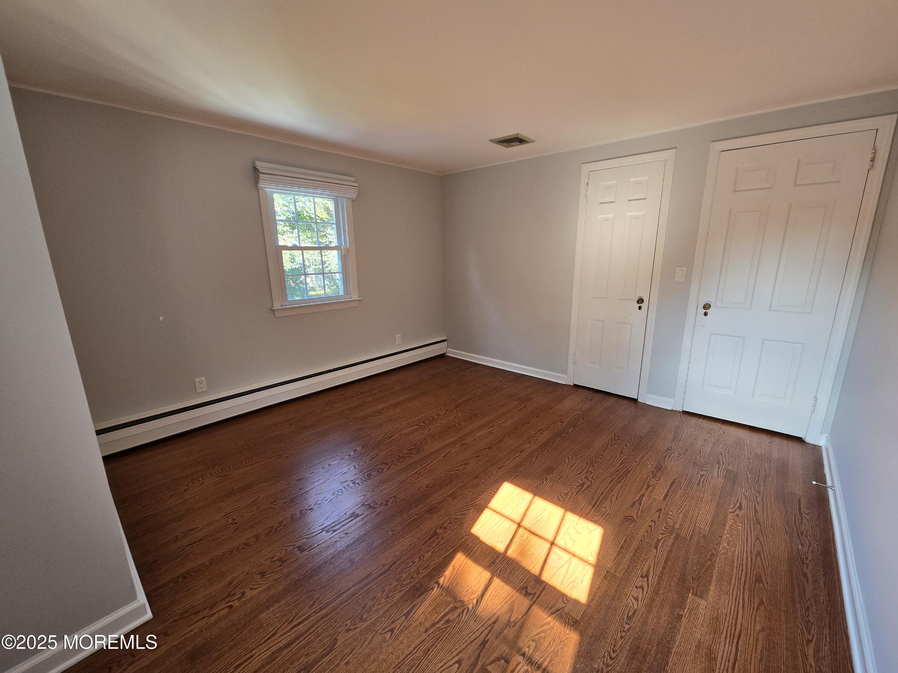 77 Dutch Lane Road Freehold, NJ 07728 - Photo 33 of 50 an empty room with wooden floor and windows