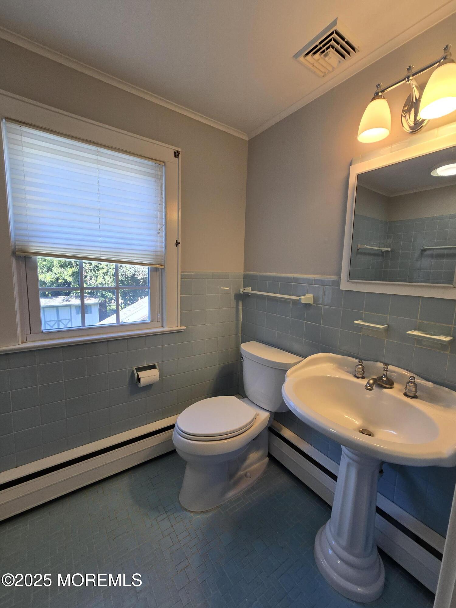 77 Dutch Lane Road Freehold, NJ 07728 - Photo 34 of 50 a bathroom with a sink a toilet and a mirror