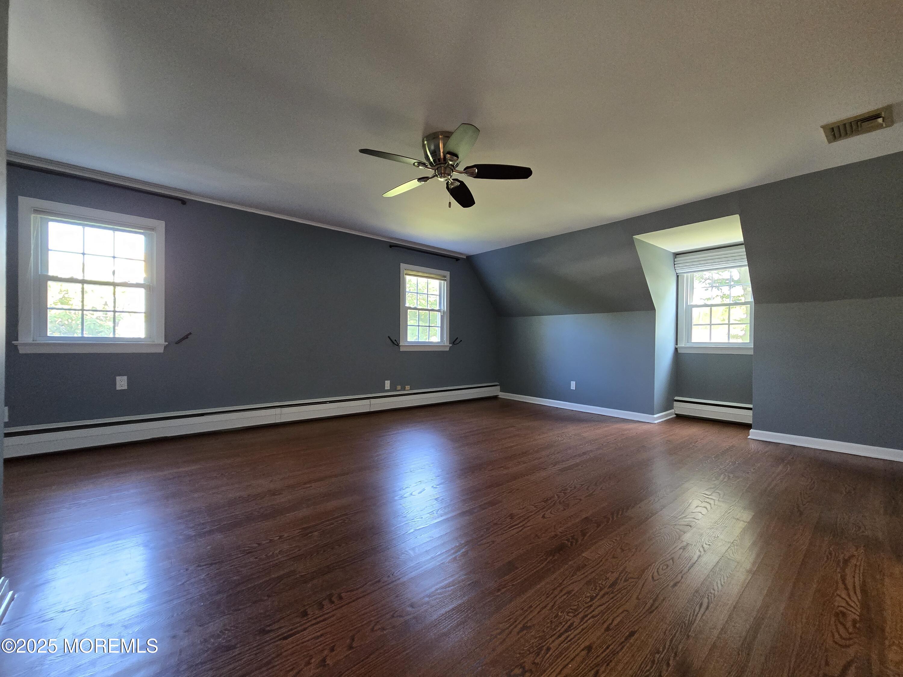 77 Dutch Lane Road Freehold, NJ 07728 - Photo 37 of 50 an empty room with wooden floor and windows