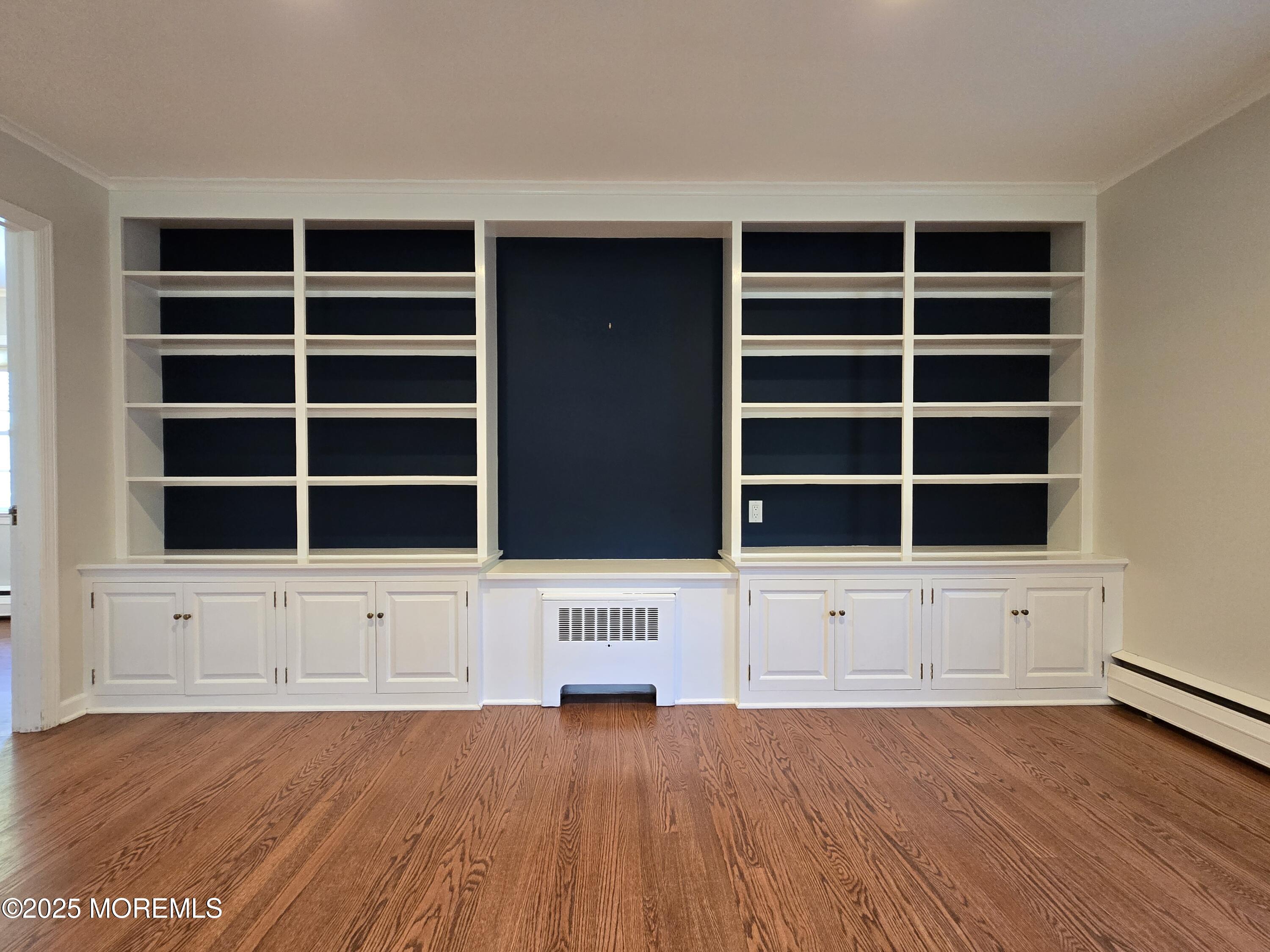 77 Dutch Lane Road Freehold, NJ 07728 - Photo 10 of 50 a view of an empty room with wooden floor and windows