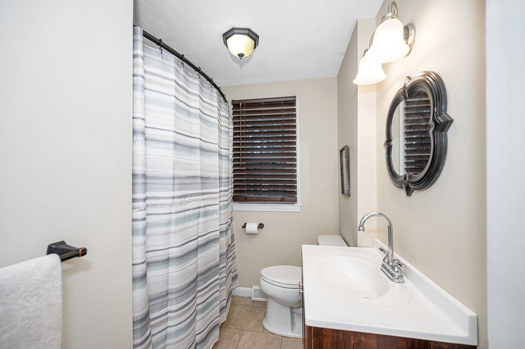 76 Maplewood Drive Townsend, MA 01469 - Photo 11 of 31 a bathroom with a sink a toilet and a mirror