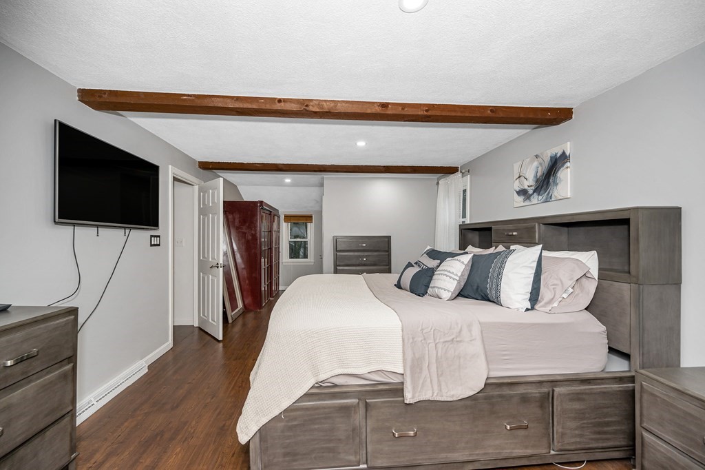 76 Maplewood Drive Townsend, MA 01469 - Photo 17 of 31 a bedroom with a bed and a flat screen tv