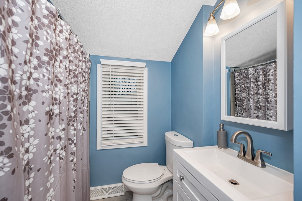 76 Maplewood Drive Townsend, MA 01469 - Photo 19 of 31 a bathroom with a toilet a sink and a window