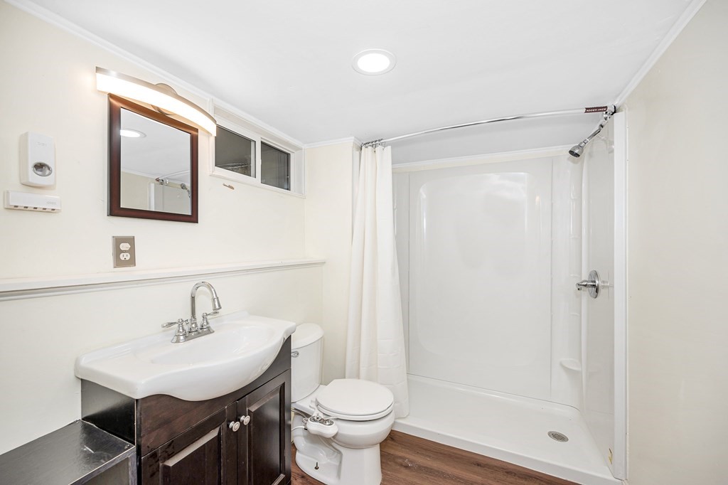 76 Maplewood Drive Townsend, MA 01469 - Photo 24 of 31 a bathroom with a sink toilet a mirror and shower