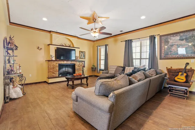 a living room with furniture a flat screen tv and a fireplace