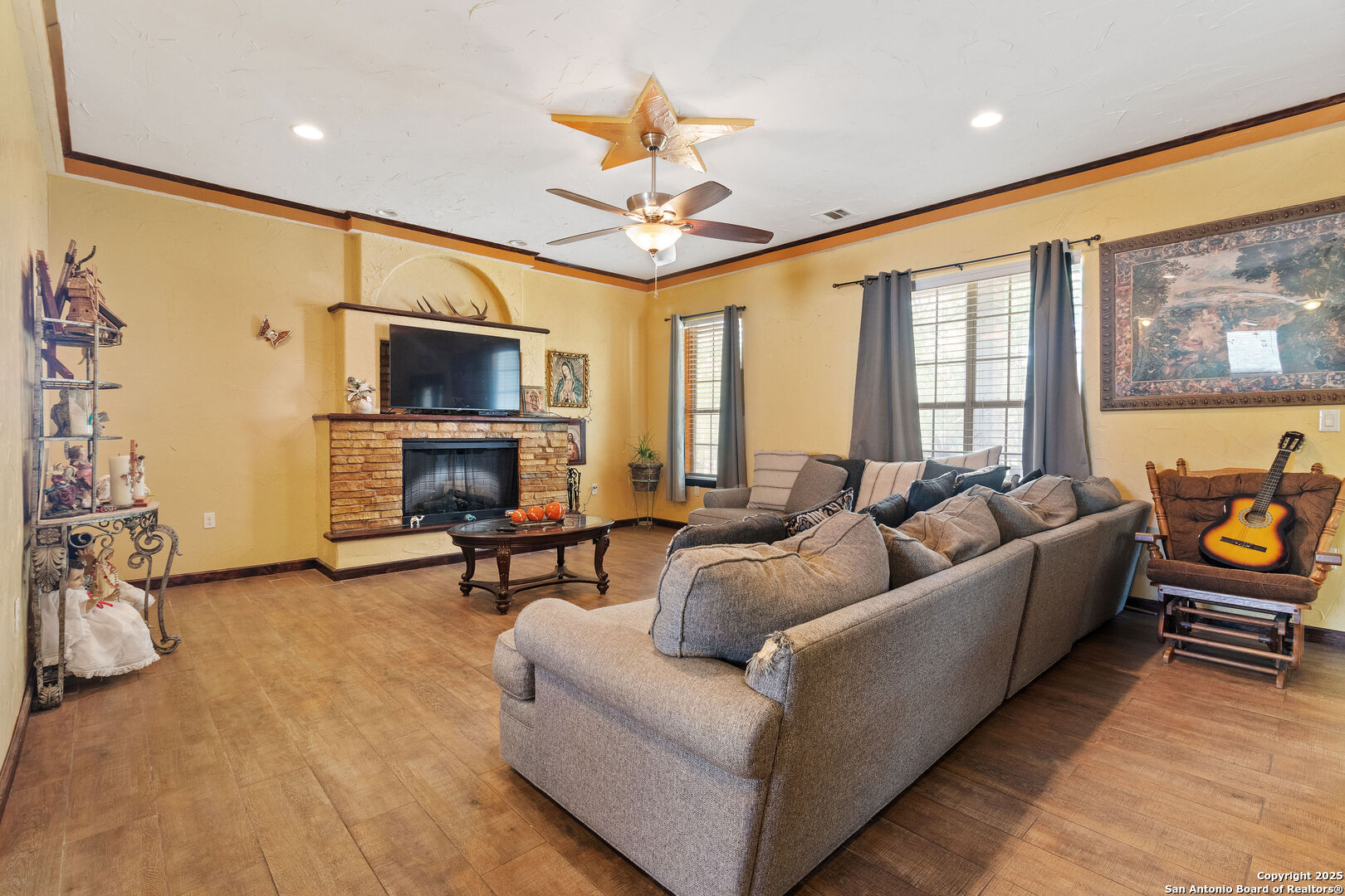 19590 Leal Road San Antonio, TX 78221 - Photo 11 of 41 a living room with furniture a flat screen tv and a fireplace
