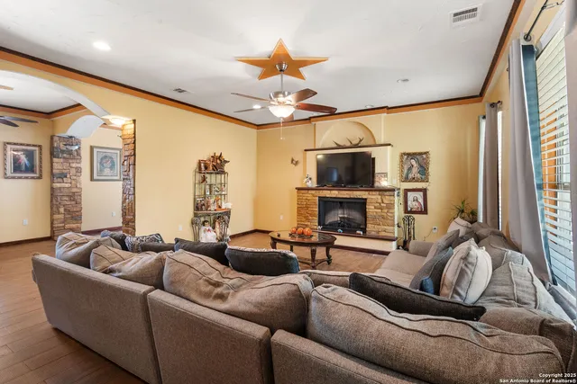 a living room with furniture a fireplace and a flat screen tv