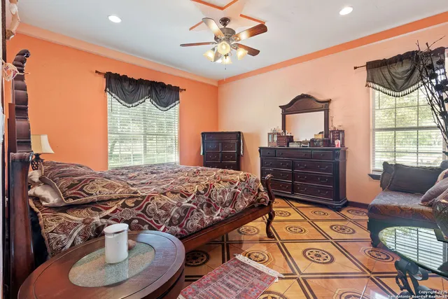 a bedroom with a bed and dresser with mirror