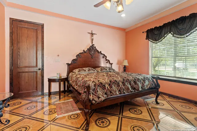 a bedroom with a bed and a window