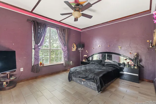 a spacious bedroom with a bed and a chandelier