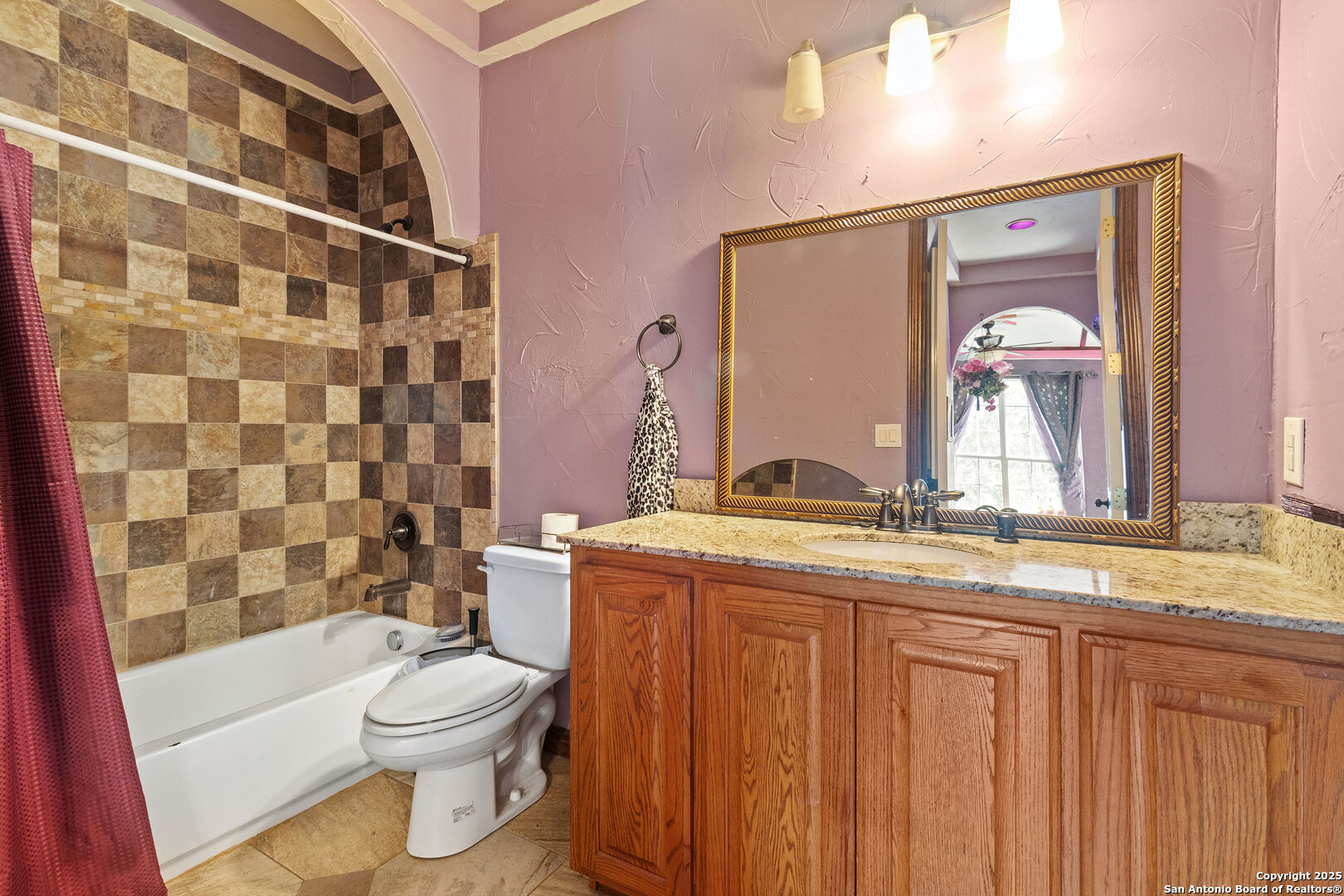 19590 Leal Road San Antonio, TX 78221 - Photo 18 of 41 a bathroom with a granite countertop toilet sink and mirror