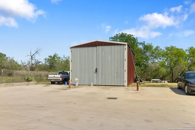 a view of car parked in front of house with a yard