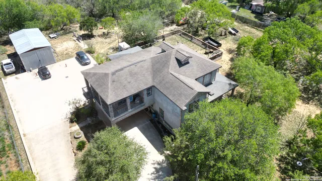 an aerial view of a house with a yard
