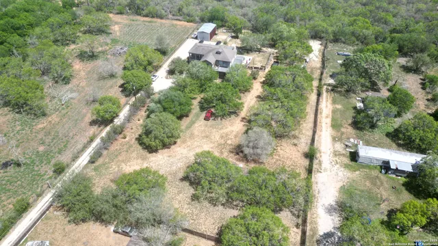 an aerial view of a house with a yard