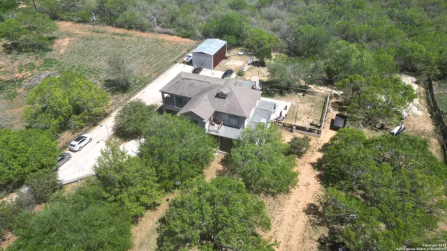 an aerial view of house with yard and outdoor seating