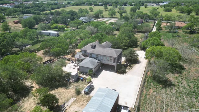 an aerial view of a house with yard