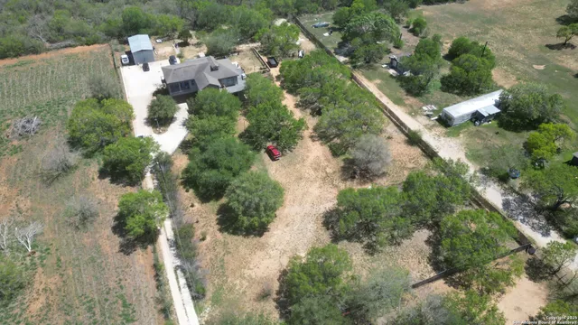 an aerial view of a house with a yard and outdoor seating